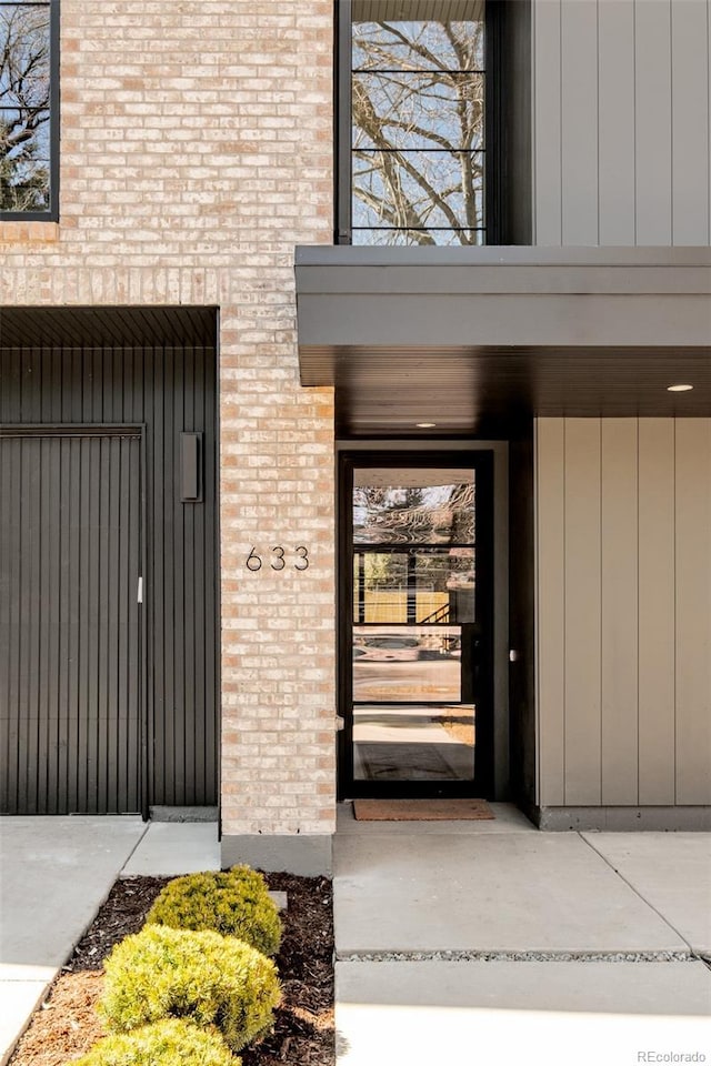 entrance to property with a balcony and brick siding