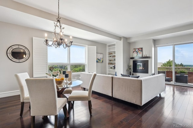 4875 S Monaco St Unit 303, Denver, CO 80237 - dining room with a chandelier, dark wood finished floors, baseboards, and built in features
