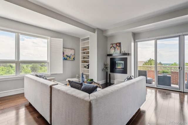 4875 S Monaco St Unit 303, Denver, CO 80237 - living room featuring dark wood finished floors and baseboards