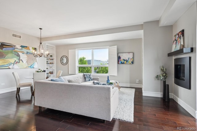 4875 S Monaco St Unit 303, Denver, CO 80237 - living area with dark wood-type flooring, baseboards, and a chandelier