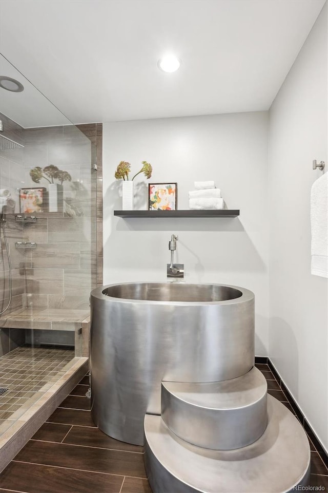 4875 S Monaco St Unit 303, Denver, CO 80237 - bathroom featuring wood tiled floors, a walk in shower, and recessed lighting