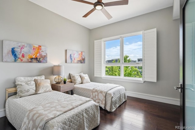 4875 S Monaco St Unit 303, Denver, CO 80237 - bedroom featuring baseboards, dark wood-style floors, and a ceiling fan