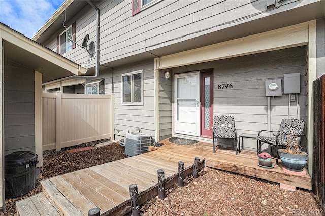 property entrance with central AC unit and fence