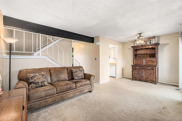 carpeted living room featuring stairway, a ceiling fan, baseboards, and a textured ceiling