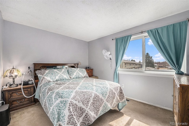 carpeted bedroom with baseboards and a textured ceiling