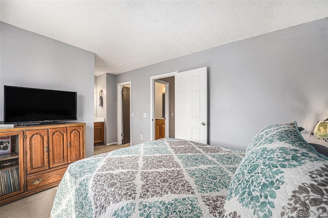 bedroom with light colored carpet and a textured ceiling