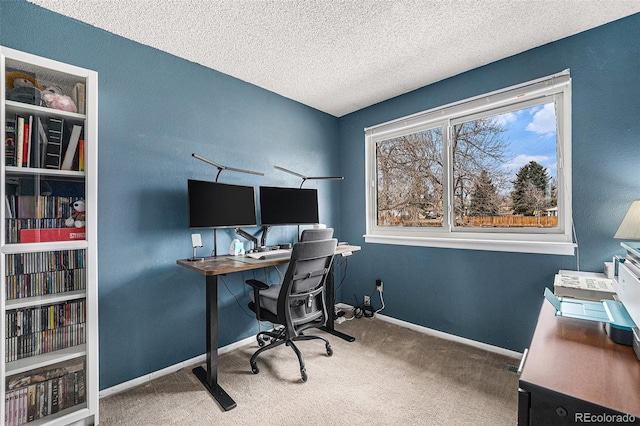 office featuring carpet flooring, a textured ceiling, and baseboards