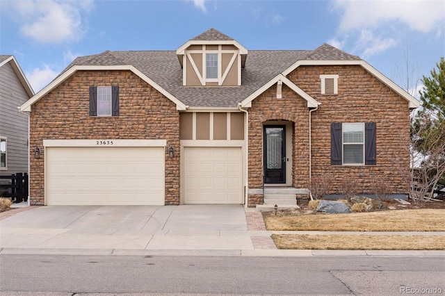view of front of property with roof with shingles, concrete driveway, a garage, and stone siding