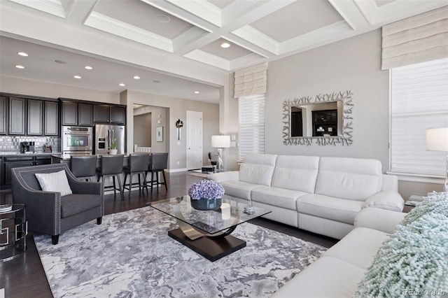 living area with recessed lighting, coffered ceiling, wood finished floors, and beam ceiling