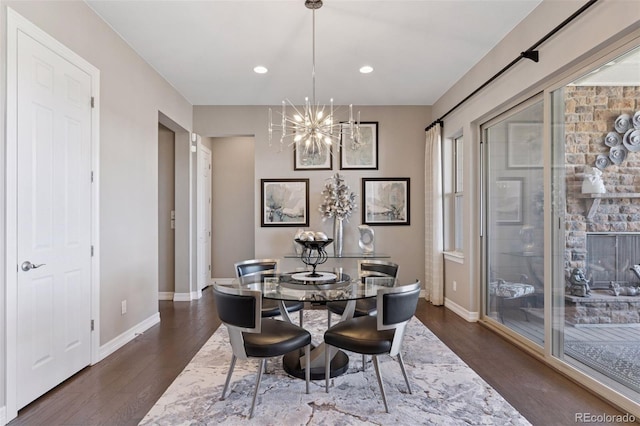dining area featuring an inviting chandelier, recessed lighting, dark wood-style flooring, and baseboards