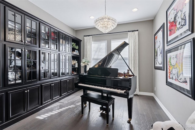living area featuring baseboards, recessed lighting, wood finished floors, and a chandelier