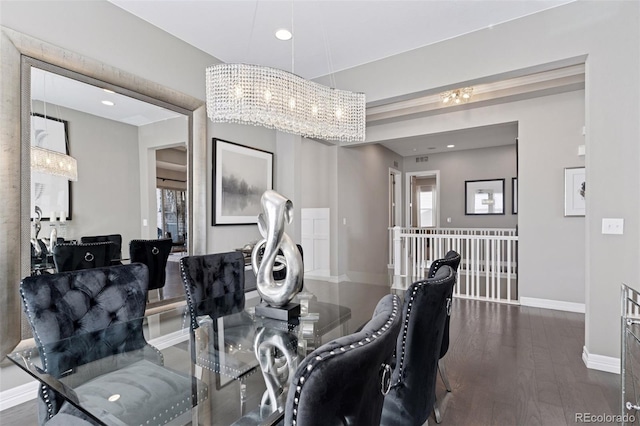dining space with baseboards, wood finished floors, a chandelier, and a wealth of natural light