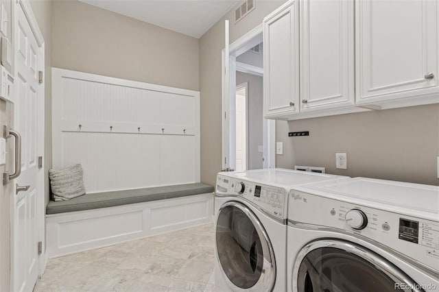 laundry area featuring cabinet space, independent washer and dryer, and visible vents