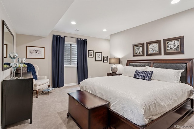 bedroom featuring baseboards, light carpet, and recessed lighting