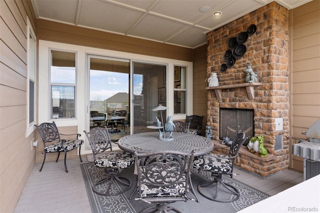 view of patio / terrace with outdoor dining space and a large fireplace