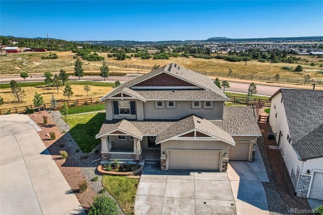 view of front of house with a rural view and a garage