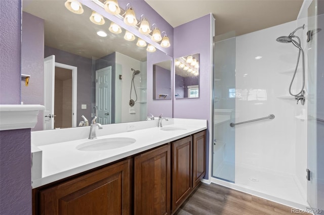 12919 W Burgundy Dr, Littleton, CO 80127 - full bath with wood finished floors, a shower stall, and double vanity