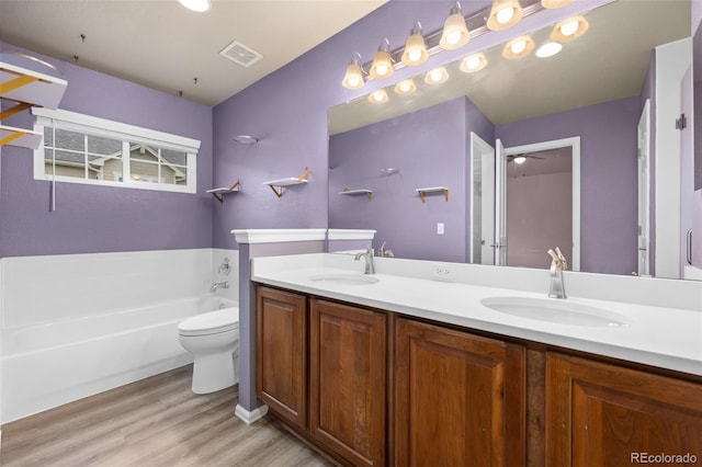 12919 W Burgundy Dr, Littleton, CO 80127 - bathroom featuring wood finished floors, a bath, and double vanity
