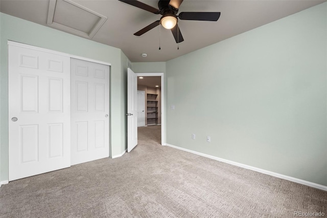 12919 W Burgundy Dr, Littleton, CO 80127 - unfurnished bedroom with attic access, carpet flooring, a closet, and a ceiling fan