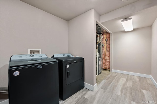 12919 W Burgundy Dr, Littleton, CO 80127 - laundry area with separate washer and dryer and light wood-style floors