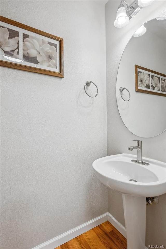 1441 S Ulster St, Denver, CO 80231 - bathroom with wood finished floors, baseboards, and a sink