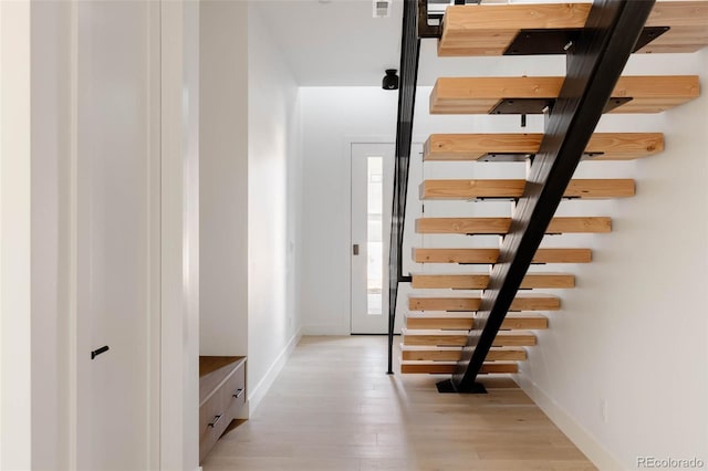 stairs with wood-type flooring