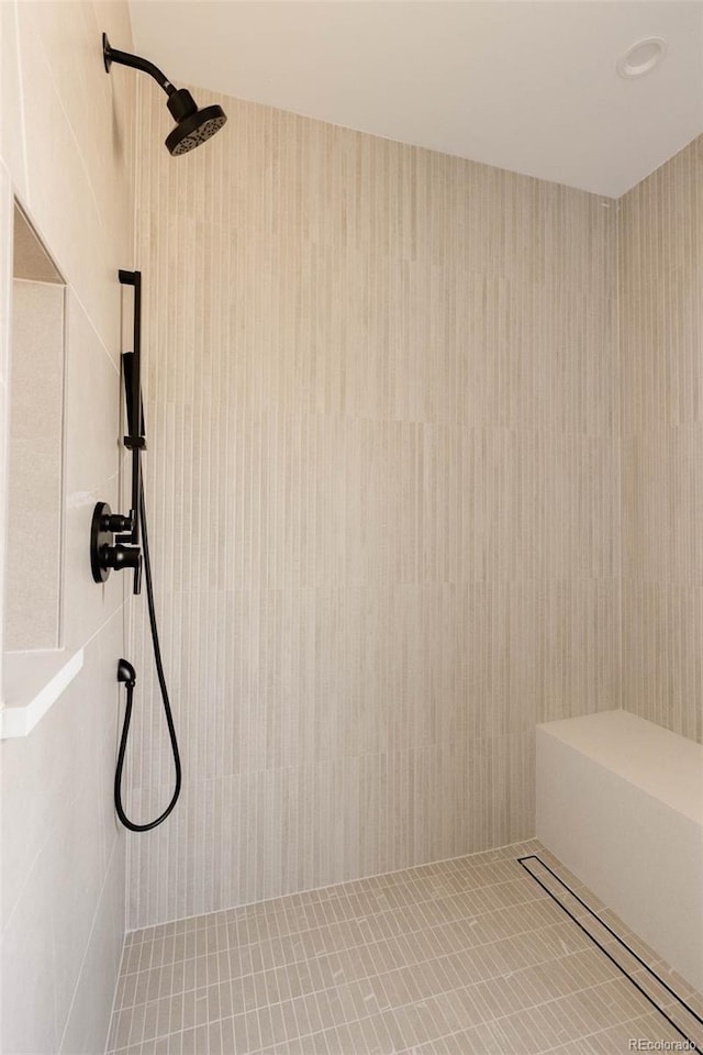 bathroom with a shower and tile patterned flooring