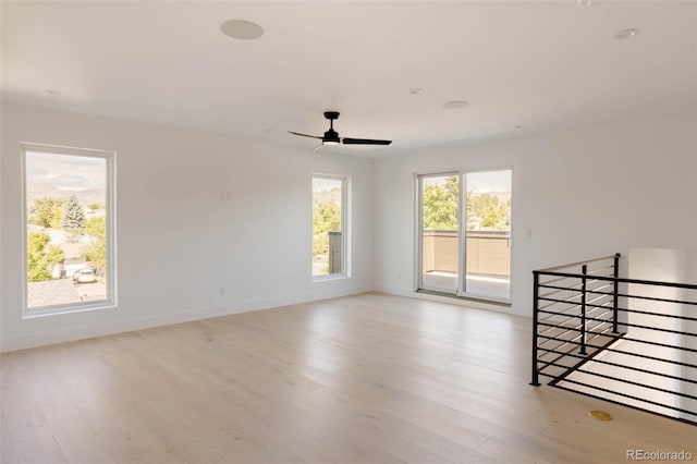 empty room featuring ceiling fan and light hardwood / wood-style flooring