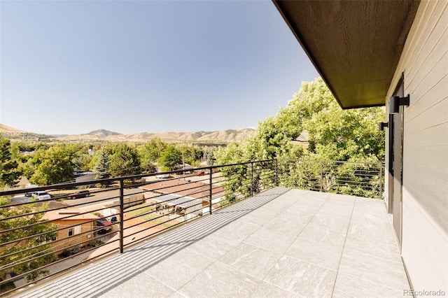 exterior space featuring a balcony and a mountain view