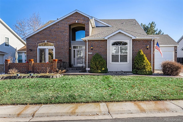 front of property featuring a front yard and a garage