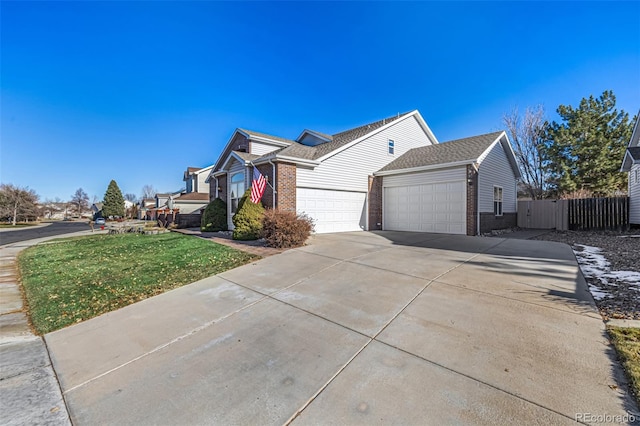 view of side of home featuring a lawn and a garage