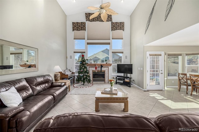 tiled living room with a wealth of natural light, ceiling fan, and high vaulted ceiling