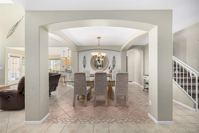 dining space with a notable chandelier and light tile patterned floors