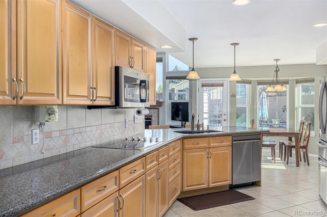 kitchen with pendant lighting, a healthy amount of sunlight, sink, and stainless steel appliances