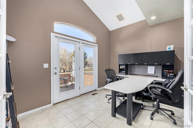 home office with light tile patterned floors and lofted ceiling