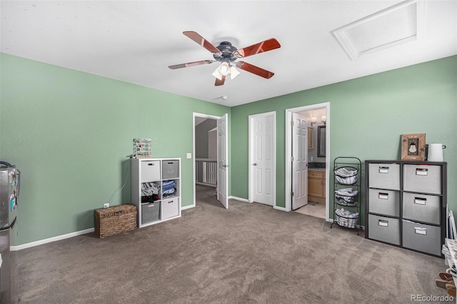 carpeted bedroom with ensuite bath and ceiling fan