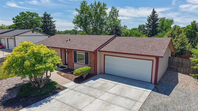 6836 W 79th Dr, Arvada, CO 80003 - ranch-style home featuring roof with shingles, driveway, and a garage