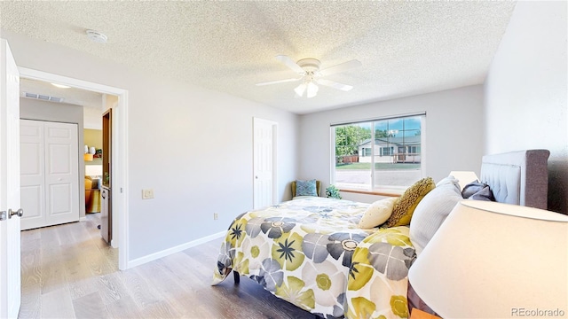 6836 W 79th Dr, Arvada, CO 80003 - bedroom featuring wood finished floors, a textured ceiling, and ceiling fan