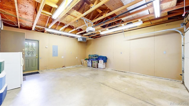 6836 W 79th Dr, Arvada, CO 80003 - garage with freestanding refrigerator, a garage door opener, and electric panel