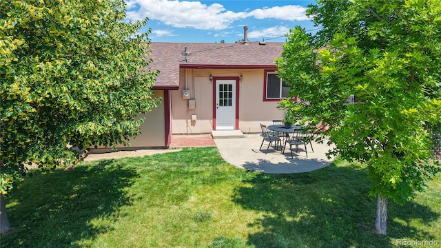 6836 W 79th Dr, Arvada, CO 80003 - back of house featuring roof with shingles, stucco siding, a yard, and a patio