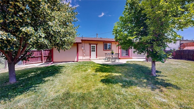 6836 W 79th Dr, Arvada, CO 80003 - rear view of house featuring stucco siding and a patio