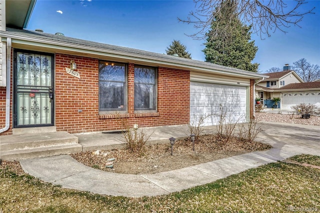 view of front of home with brick siding, driveway, and an attached garage