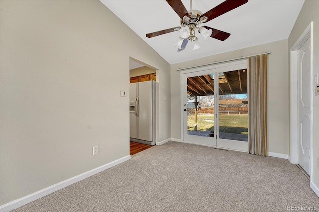 carpeted spare room featuring baseboards, visible vents, a ceiling fan, and lofted ceiling