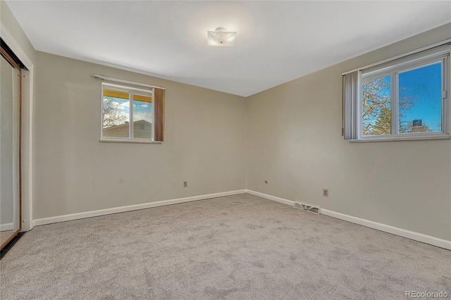 unfurnished bedroom with a closet, baseboards, visible vents, and carpet floors