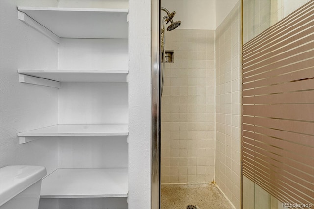 full bathroom featuring a stall shower and toilet