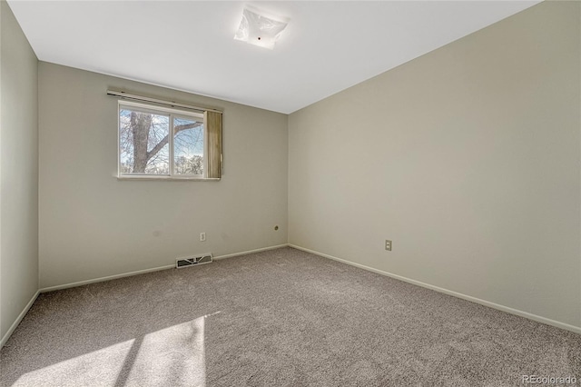 spare room with visible vents, baseboards, and carpet