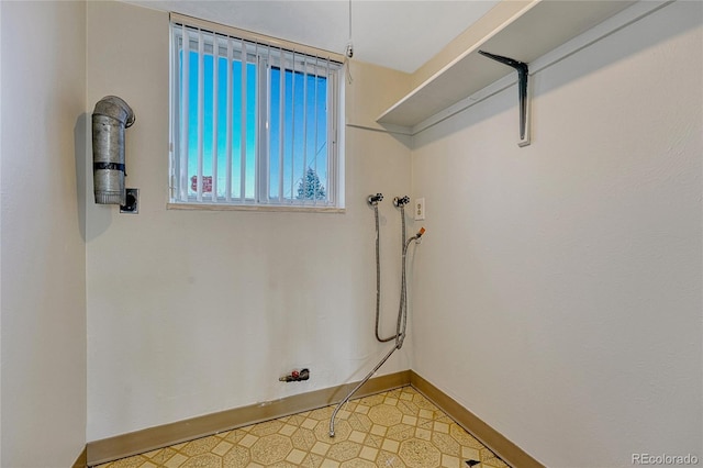 washroom featuring washer hookup, laundry area, baseboards, and tile patterned floors