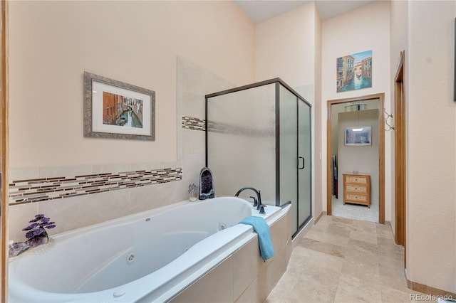 bathroom featuring separate shower and tub