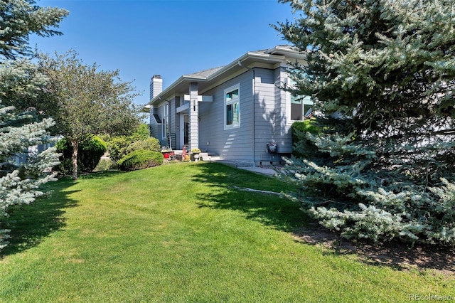 view of side of home featuring a yard