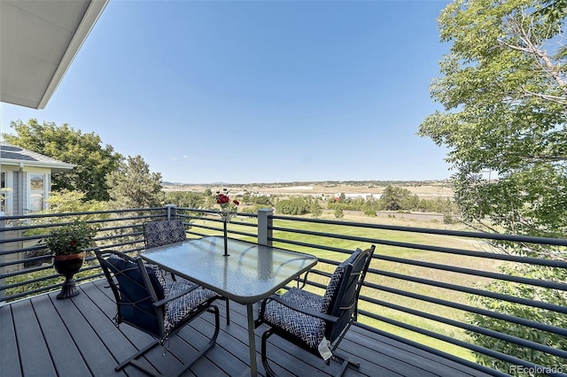 wooden terrace with a lawn